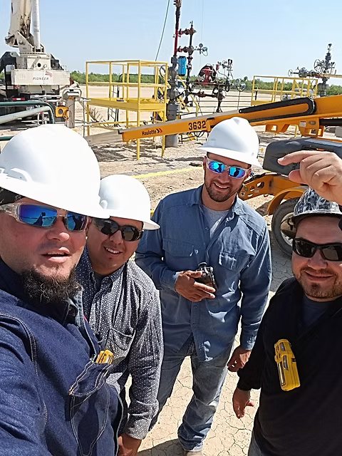 LARM Enterprises crew wearing hard hats at a well pad